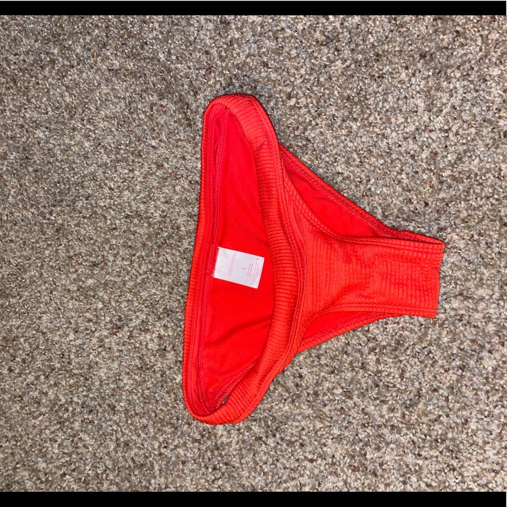 Red swim bottoms size S with ribbed detailing. Never worn.
